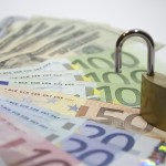 foreign currency and a padlock