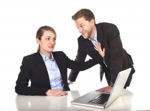 woman pushing man away in work setting